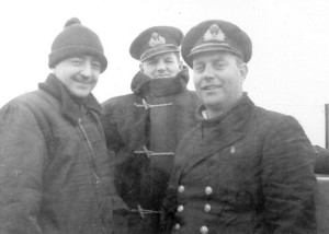 Lieutenant William Harrison, Commanding Officer of HMCS TRENTONIAN (right) with Sub-Lieutenant C. LaRose (left), Lieutenant Burley Kinsmen (Centre) on TRENTONIAN's bridge during convoy duty on the North Atlantic in March 1944. Roger Litwiller Collection, courtesy Bruce Keir, RCNVR. (RTL-BK038)