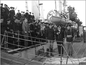 Rear-Admiral L.W. Murray, Flag Officer Newfoundland, greets the crew of the destroyer Assiniboine at St. Johnâ€™s after their sinking of U-210 on 6 August 1942; the shipâ€™s captain, Lieutenant- Commander John Stubbs (right), would be lost with his next ship, Athabaskan. RCN Photo.