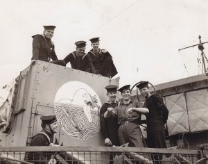 Sailors from HMCS REGINA (1st) display thier Gunshield art, proudly displayed on the corvette's forward gun. Photo courtesy For Pasterity's Sake.