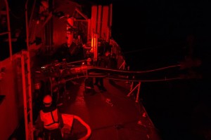 Under red light sailors in Her Majestyâ€™s Canadian Ship (HMCS) Toronto conducts a night time Replenishment At Sea (RAS) with the French Supply Ship A630 Marne on October 20, 2014 during Operation REASSURANCE in the Mediterranean Sea. RCN Photo. (HS2014-A158-014)