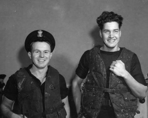 Petty Officer Ray Lounsbury (right) and Petty Officer Bernard Roden , both of Vancouver, BC. demonstrate the RCN issue lifejackets that saved their lives when HMCS TRENTONIAN was torpedoed on 22 February 1945. Roger Litwiller Collection, courtesy Douglas Campbell, RCNVR.