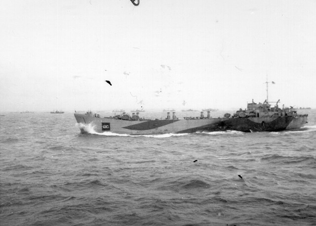 A landing ship drives towards the beaches of Normandy, with a multitude of ships in the background. Photo taken from HMCS TRENTONIAN on 7 June 1944.
Roger Litwiller Collection, Allen B. Singleton, RCNVR photo, courtesy Bruce Keir, RCNVR. (RTL-BK091)