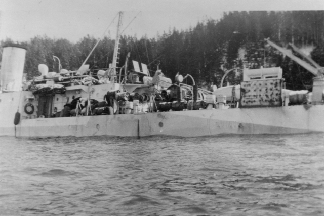 HMCS QUINTE, Bangor class minesweeper, had grounded on Horse Head Shoal on 30 Novemeber 1942. She quickly began to take on water and was beached near St. Peter's, Cape Breton. Salvage operations on QUINTE were begun by the Foundation Maritime Ltd’s ship Foundation Aranmore.
She was re-floated ten days later and moved to the wall at St. Peter's Canal to continue pumping operations
Unfortunately for QUINTE her ordeal was not yet over, she capsized in St. Peters Canal during salvage operations. QUINTE has the dubious distinction of being the only Royal Canadian Navy ship to sink twice in ten days. Discover the remarkable story of HMCS QUINTE in Warships of the Bay of Quinte.
Roger Litwiller Collection -Photo Courtesy Walter Gregory. (RTL-WG005)