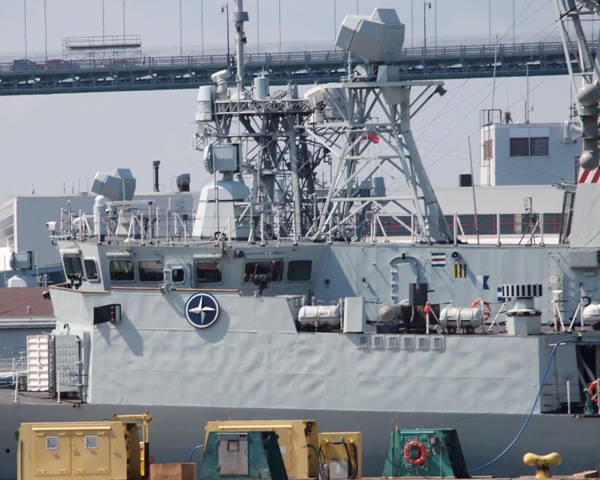 HMCS CHARLOTTETOWN has her NATO shield on the bridge, as the frigate is readied for her six month deployment on 4 August 2017. Roger Litwiller Collection, courtesy Roger Litwiller. (RTL44719)