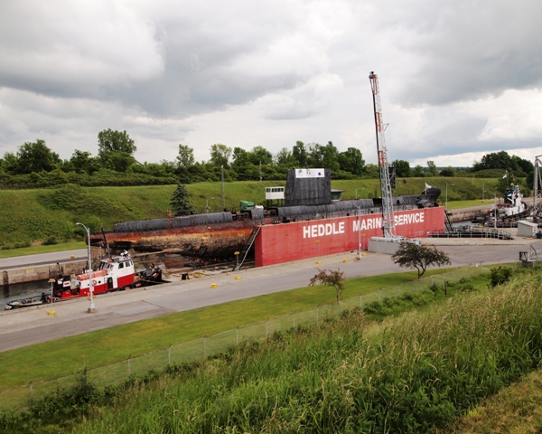 Tugs Florence M. (leading) and Lac Manitoba ease former HMCSubmarine OJIBWA through the Iroquois Lock on the St. Lawrence Seaway on 3 June 2012.

Roger Litwiller Collection, courtesy Roger Litwiller. (RTL33805)