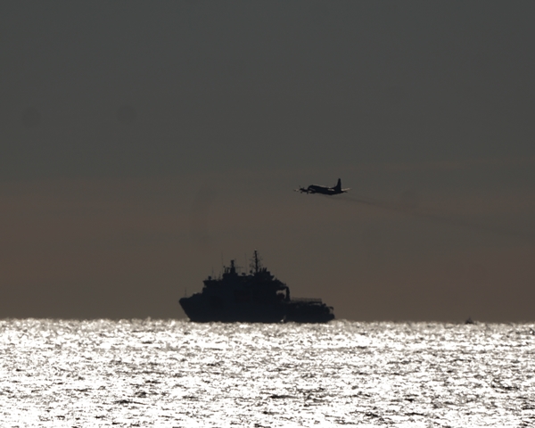 A CP-140 Aurora from 415 Squadron RCAF conducts a flypast over HMCS HARRY DEWOLF off Peggy's Cove, Nova Scotia on 15 December 2021. The Arctic and Offshore Patrol Ship was homeward bound after circumnavigating North America. Roger Litwiller Collection, courtesy Roger Litwiller. (RTL01099)