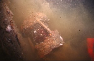 Screen shot from a 2018 dive video of HMCS TRENTONIAN's port navigation lamp, lying on the wreck.