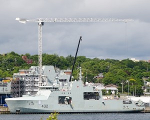 The future HMCS Max Bernays is finishing construction alongside the wall at Irving Shipyard in Halifax on 22 June 2022. The 4th Artic and Offshore Patrol Ship, William Hall is behind on the assembly pad. Roger Litwiller Collection, courtesy Roger Litwiller. (RTL03433)